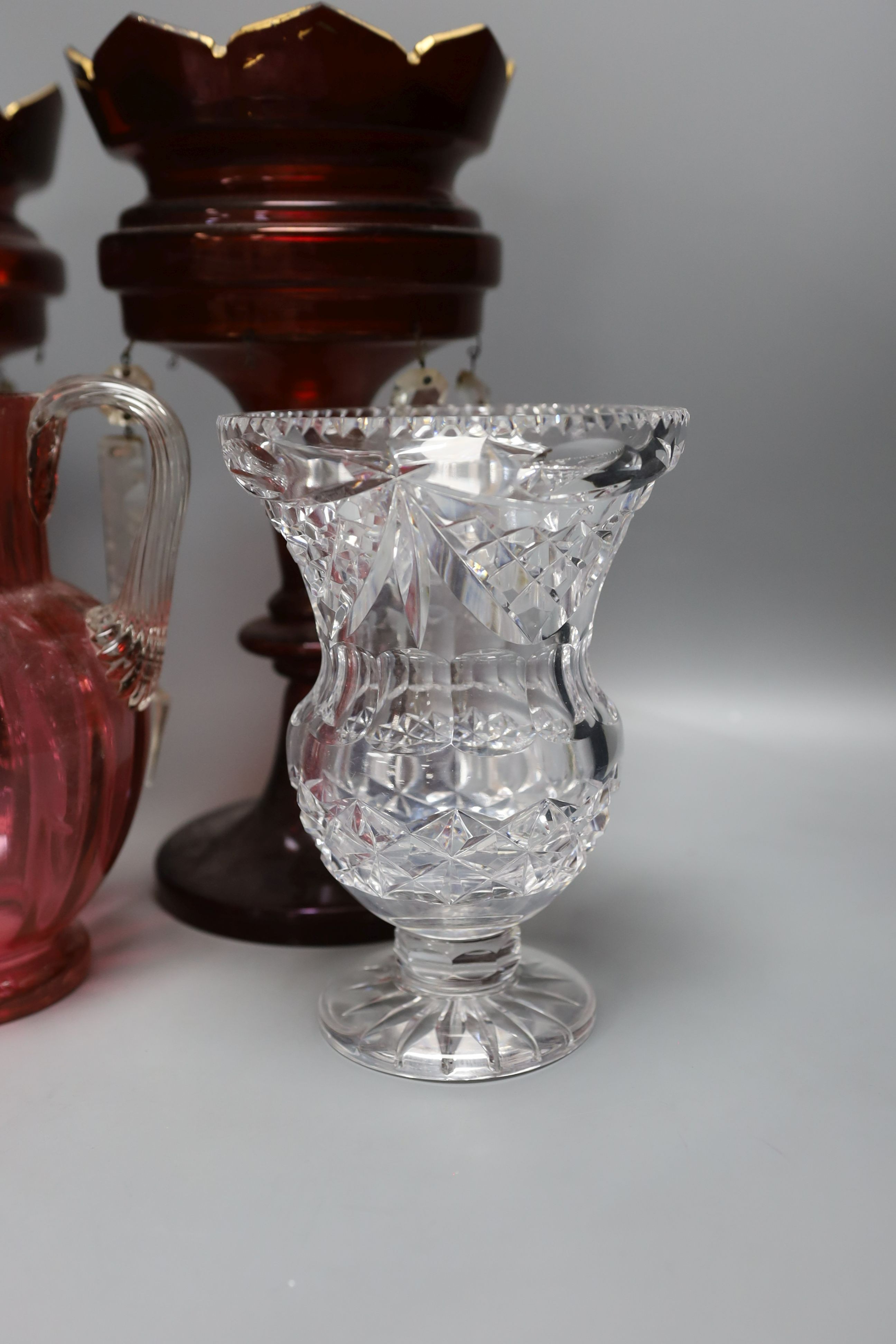 A pair of late 19th century ruby glass lustres, 30cm tall, cranberry jug, Bohemian vase and one other (5)